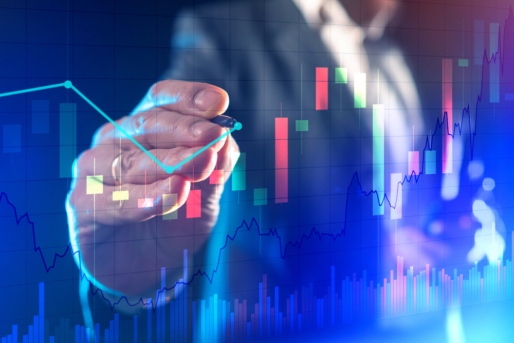 Business professional analyzing financial charts, representing labor supply and demand trends in the evolving job market.