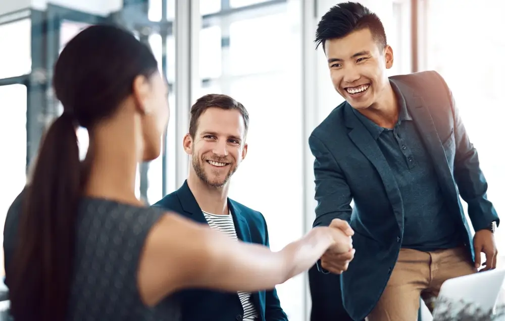 Man, woman and handshake in office at business meeting with smile for welcome, introduction and respect at job.